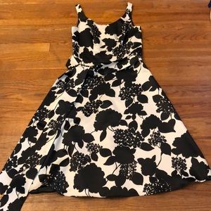 Black and white silk dress with tie around waist.